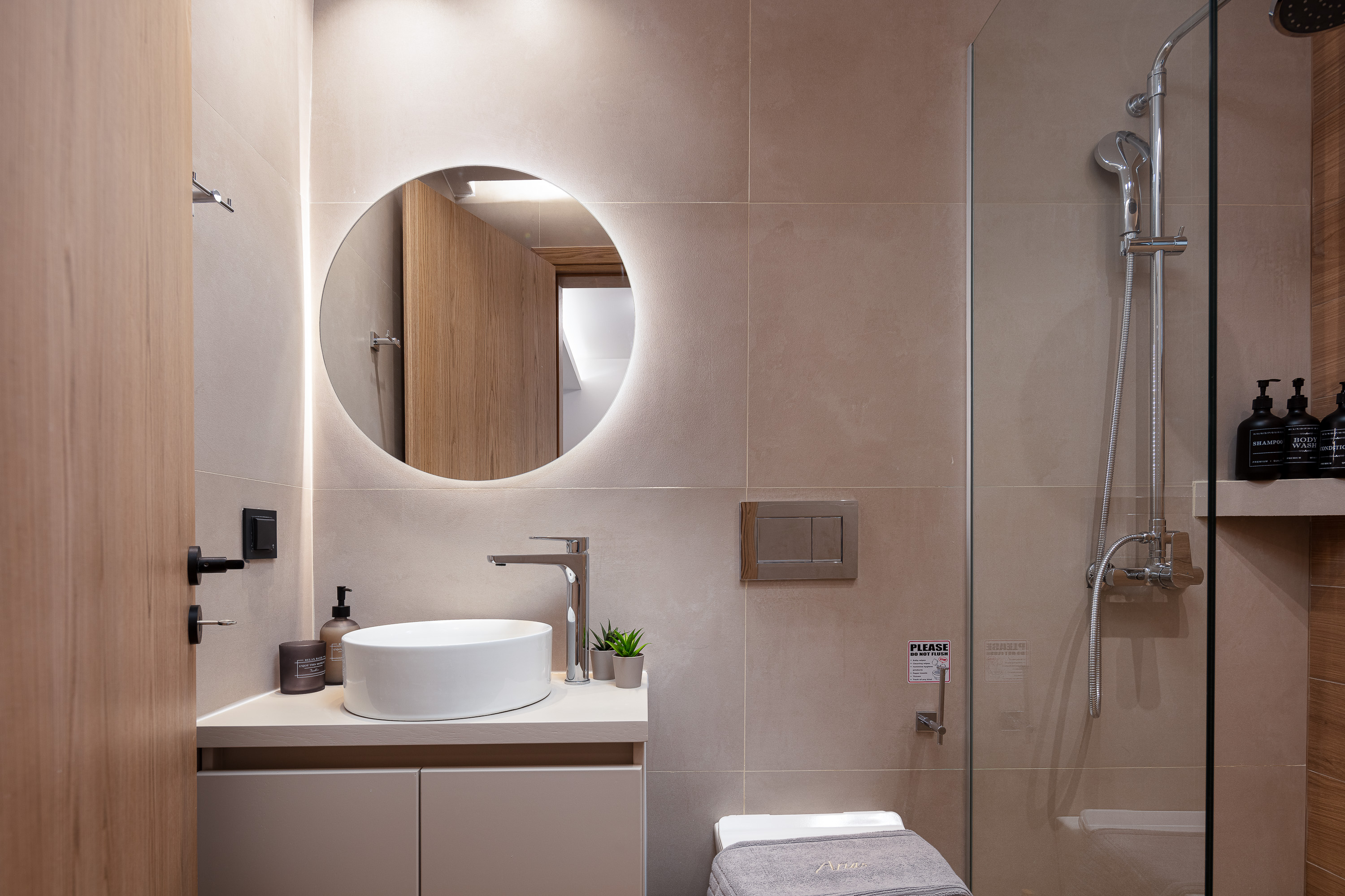 Ensuite bathroom with backlit mirror โ luxury apartment Rethymno